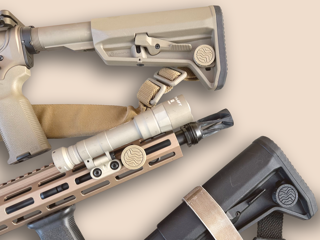 Three CHIP CR2032 battery holders installed on two rifle buttstocks and an M-LOK handguard