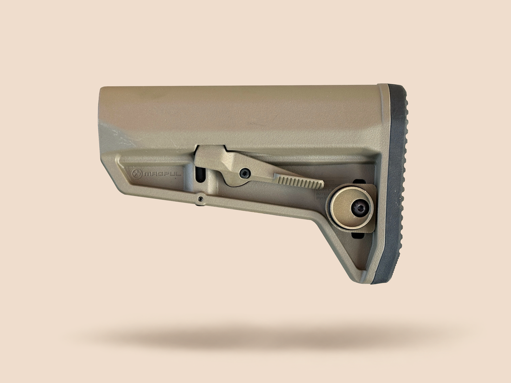 CHIP battery holder open and empty on a tan rifle stock, showing the housing and screw
