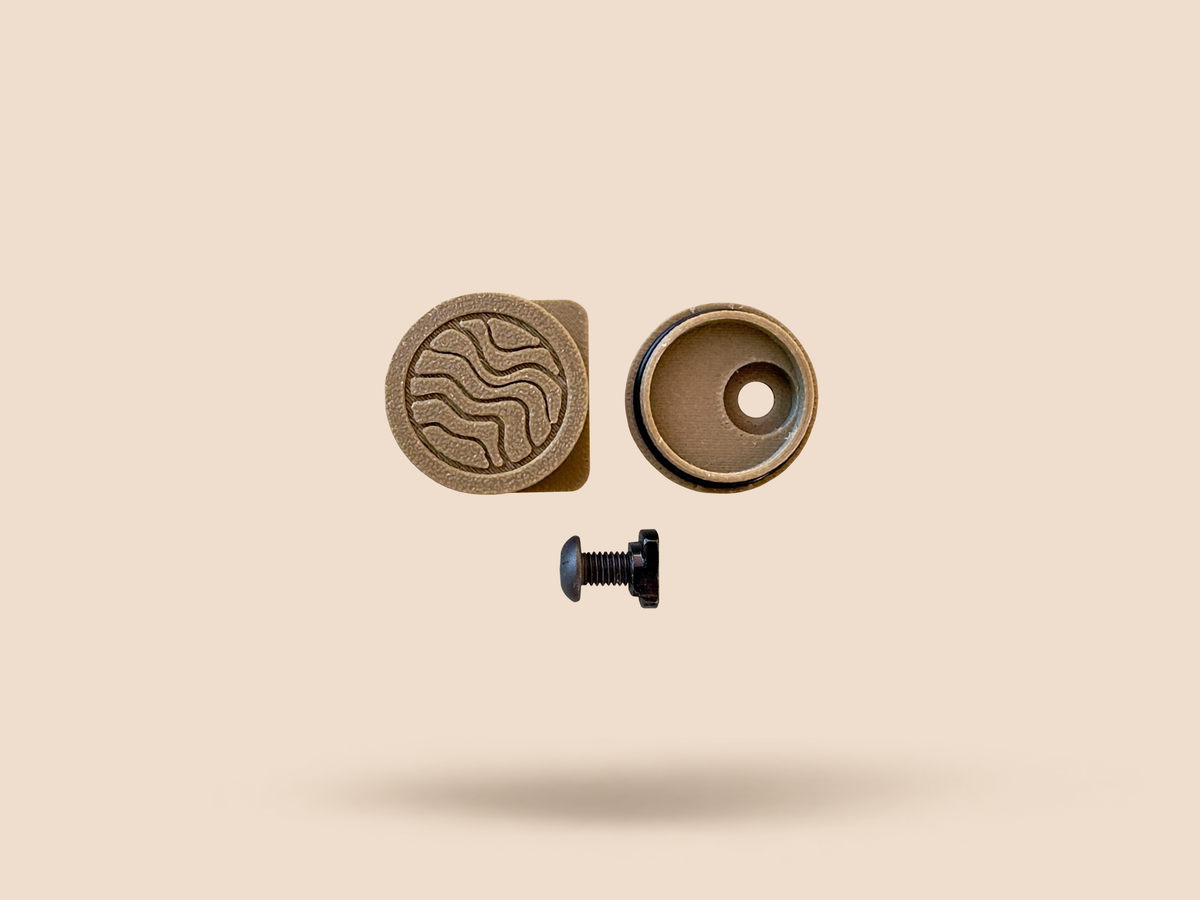 CHIP battery holder in Tan, disassembled: logo cap, housing and mounting screw