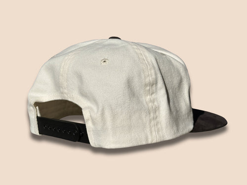 Lightning Bolt Snapback Hat in cream/black showing the back of the hat with a black snap closure