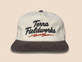 Lightning Bolt Snapback Hat in cream/black with black puff embroidered Terra Fieldworks script and orange lightning bolt