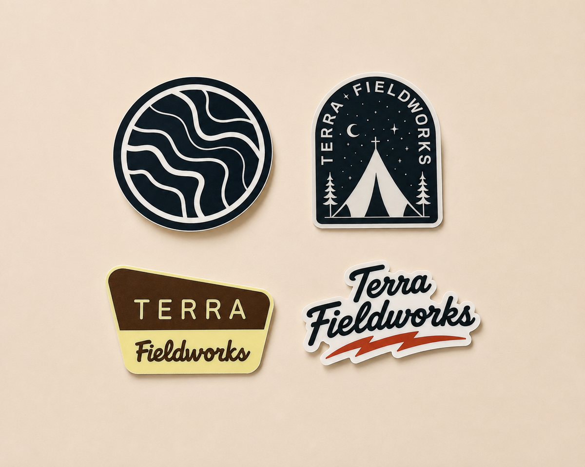 Terra Fieldworks sticker pack: topographic circle logo, tent badge, national forest inspired logo, and lightning bolt script